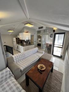 a living room with a couch and a table at Bodrum Center 2plus1 for 6 people - Citak Mansions in Bodrum City