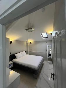 a bedroom with a white bed in a room at Bodrum Center 2plus1 for 6 people - Citak Mansions in Bodrum City