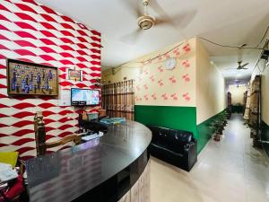 a bar in a restaurant with a red and white wall at Hotel Rongdhanu Residential in Dhaka