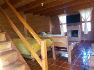a bedroom with a bed and a fireplace in a room at Cabaña en El Zembo, Huasca de Ocampo in Huasca de Ocampo