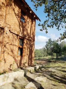 an old brick building with a window on the side at Cabaña en El Zembo, Huasca de Ocampo in Huasca de Ocampo