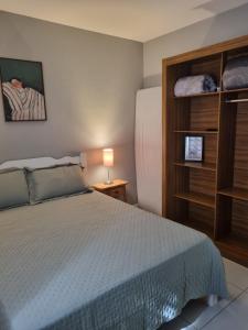 a bedroom with a bed and a book shelf at A 700m da Praia e do Shopping, Liberdade, Churrasq, Garagem e Estaciona Livre in Balneário Camboriú