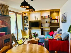 a living room with a couch and a table at Chalet Jonquille in Valfréjus