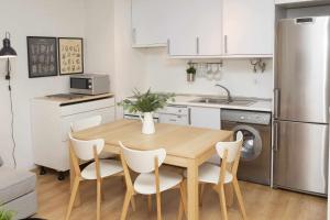 a small kitchen with a wooden table and chairs at Casa Abedul by BeValle in Panticosa
