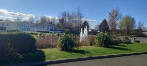a garden with a fountain in the middle of a yard at Happy Holiday Seton Sands in Port Seton