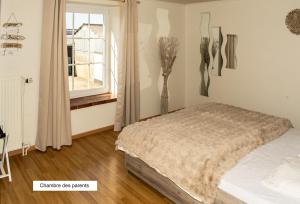 a bedroom with a bed and vases on the wall at Gîte Chez Cyrille in Houffalize +28 photos