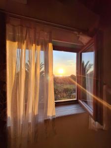a window with a view of a sunset at Come a Casa in Santa Maria del Cedro +15 photos
