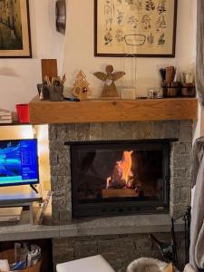 a living room with a fireplace with a fire at Chalet CHIARA&CARLO in Bormio