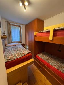a bedroom with two bunk beds and a window at Chalet CHIARA&CARLO in Bormio +13 photos