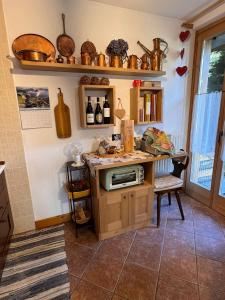a kitchen with a counter and a table with a microwave at Chalet CHIARA&CARLO in Bormio