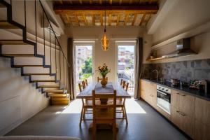 a kitchen with a table and chairs and a staircase at Loft di design Wi-Fi e Clima in Porto SantʼElpidio