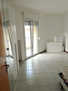 a room with white walls and a room with sliding glass doors at Vacanze MARE Vasto in Vasto