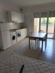 a kitchen with a wooden table and a kitchen with a stove at Vacanze MARE Vasto in Vasto