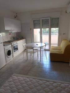 a kitchen and living room with a table and a couch at Vacanze MARE Vasto in Vasto