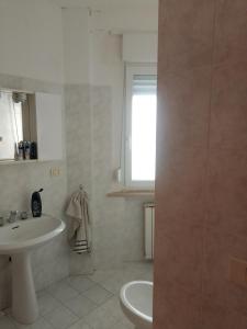 a white bathroom with a sink and a toilet at Vacanze MARE Vasto in Vasto