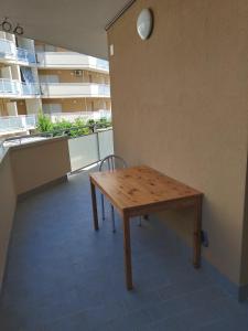 a wooden table and chair in a room with a building at Vacanze MARE Vasto in Vasto +3 photos
