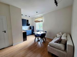 a living room with a couch and a table at Apartament w Starym Koszarowcu in Borne Sulinowo