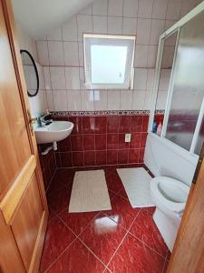 a bathroom with a toilet and a sink at Villa E&M in Srebrenik
