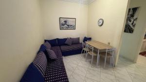a living room with a couch and a table at Appartement plage kozah in Tangier