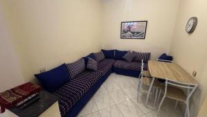 a living room with a couch and a table at Appartement plage kozah in Tangier +34 photos
