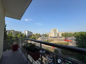 a balcony with two chairs and a view of a city at Pilot House in Mykolaiv