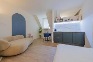 a living room with a couch and a kitchen at City Mini Studio in Bratislava