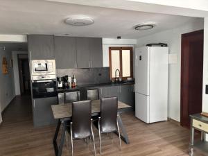 a kitchen with a table and chairs and a refrigerator at Brisa Marina in Cullera