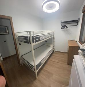a bunk bed in a room with a light at Brisa Marina in Cullera +2 photos