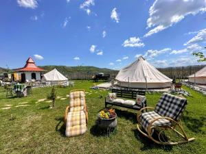 a group of chairs and a tent in a field at Pyramid Retreat in Sebeş