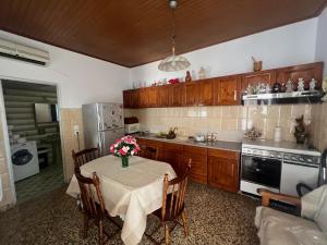 a kitchen with a table with a vase of flowers on it at Gennadi Sunrise in Gennadi