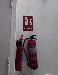 two fire hydrants are hanging on a wall at Sunny apartment la huerta in Alicante