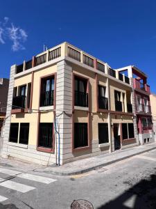a building on the corner of a street at Sunny apartment la huerta in Alicante +4 photos