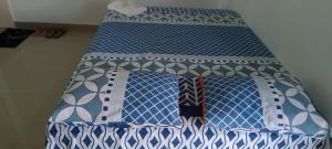 a bed with blue and white sheets and ties at CAMAS & CAFÉ 24 Horas Express in Tarapoto