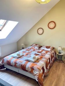 a bedroom with a large bed in a attic at Le Parisien in Le Mans
