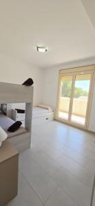 a white room with a large window and a couch at Vistamar in Les tres Cales