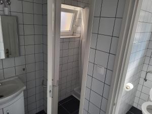 a bathroom with a shower with a sink and a toilet at Villa Balifornia in Balatonboglár +36 photos