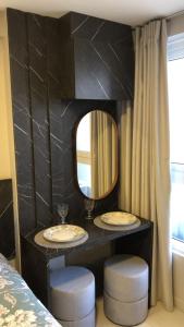a black bathroom with two sinks and a mirror at Flat 201 Paradise in João Pessoa