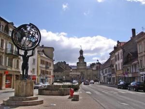 a statue of a woman with a bicycle on a city street at Le Cocon Saint-Pierre in Pontarlier