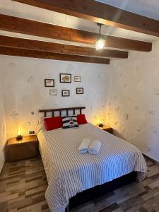 a bedroom with a bed with two pillows on it at Seafront House in Tufia in Telde