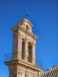 a clock tower on top of a building at Fantástico duplex en el centro de Osuna in Osuna +5 photos