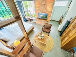 a room with a bed and a table and a couch at 202MSNK Luxe Studio w Balcony & Kitchen in Can Tho