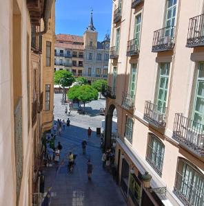 a group of people walking down a street between buildings at Hotel Spa La Casa Mudéjar in Segovia