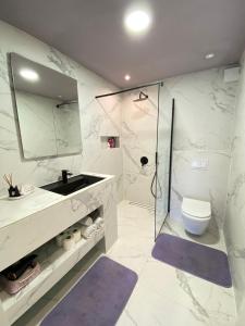 a bathroom with a sink and a toilet and a mirror at Kuća sa bazenom Sarajevo - Lavanda Estate in Sarajevo +18 photos