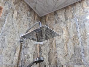 a shower in a bathroom with a stone wall at Big villa ISK in Gabala +34 photos