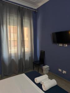 a bedroom with a bed and a tv and a chair at Dream Guest House in Pisa +83 photos