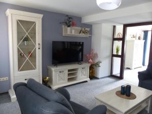 a living room with a couch and a television at Ferienwohnung Jesse in Braunlage
