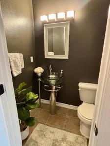 a bathroom with a sink and a toilet at In the Heart of Town-3BR-2bath-500Mbps WiFi-4car parking-EV-boat in Florence