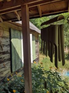 a group of utensils hanging from a wooden structure at Leśna Chata Polesie  +11 photos
