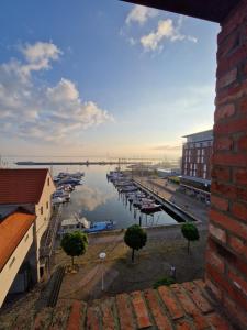 a view of a harbor with boats in the water at Ferienwohnung Hafenpanorama Speicherresidenz Barth 4 5 in Barth