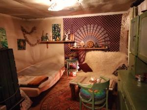 a bedroom with a bed and a table in it at Leśna Chata Polesie 